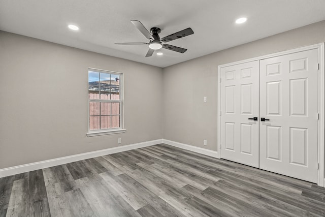 unfurnished bedroom featuring a closet, ceiling fan, and hardwood / wood-style flooring