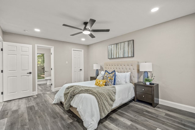 bedroom featuring connected bathroom, dark hardwood / wood-style floors, and ceiling fan