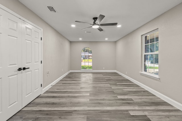 empty room featuring ceiling fan and light hardwood / wood-style flooring