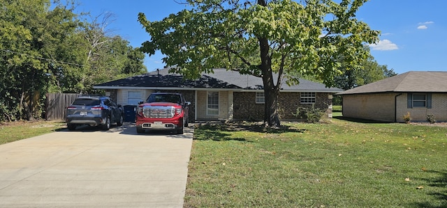 single story home with a front yard and a garage