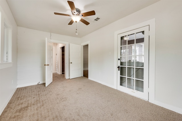 unfurnished bedroom featuring light colored carpet and ceiling fan