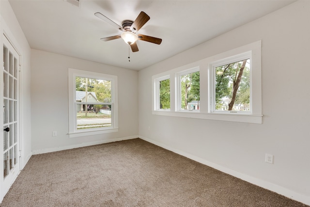 empty room with ceiling fan and carpet floors