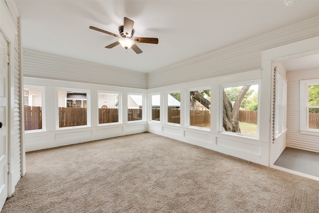 unfurnished sunroom with ceiling fan