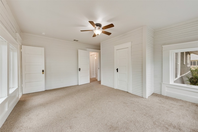 unfurnished bedroom featuring ceiling fan and carpet flooring