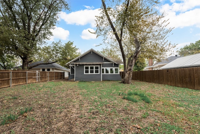 back of house with a yard