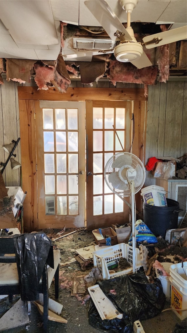 miscellaneous room featuring wood walls