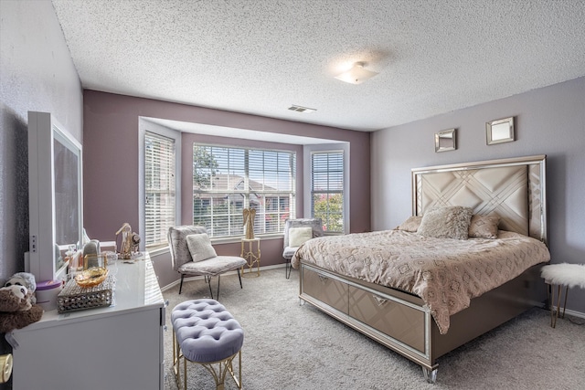 bedroom featuring a textured ceiling and carpet floors