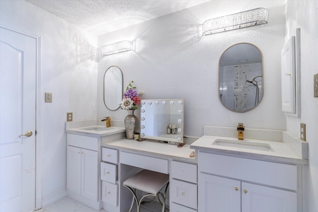 bathroom featuring a textured ceiling, walk in shower, and vanity