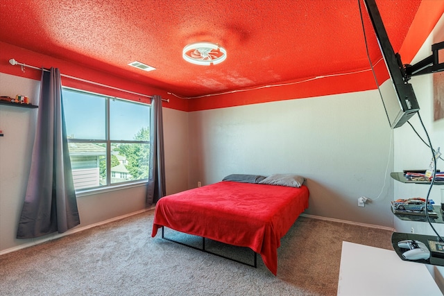 carpeted bedroom with a textured ceiling