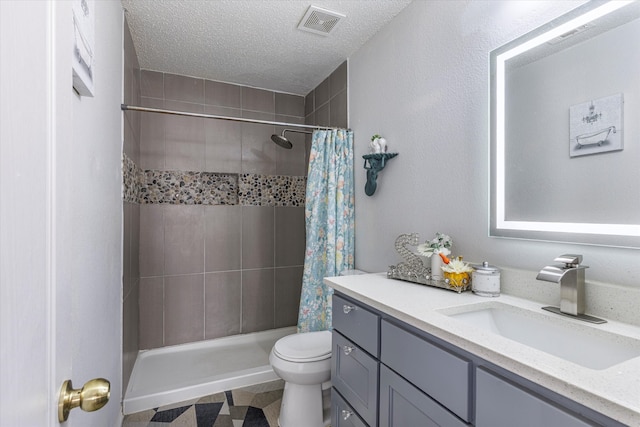 bathroom featuring a shower with curtain, vanity, toilet, and a textured ceiling