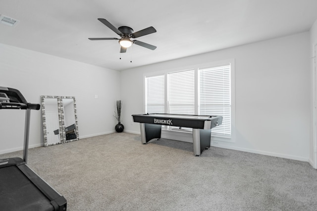 interior space featuring light carpet and ceiling fan