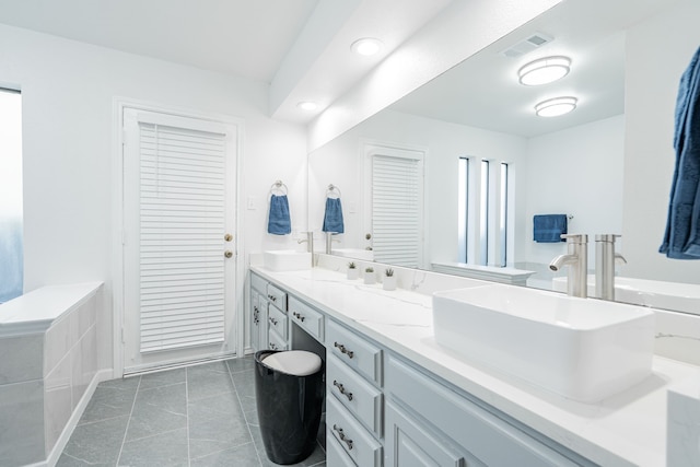 bathroom with tile patterned flooring and vanity