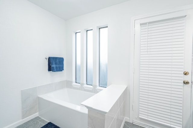 bathroom featuring tiled bath and tile patterned floors