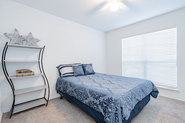 bedroom with ceiling fan and light colored carpet