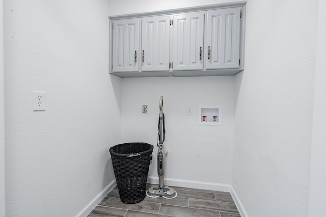 laundry room featuring hookup for an electric dryer, cabinets, hookup for a washing machine, and hardwood / wood-style flooring