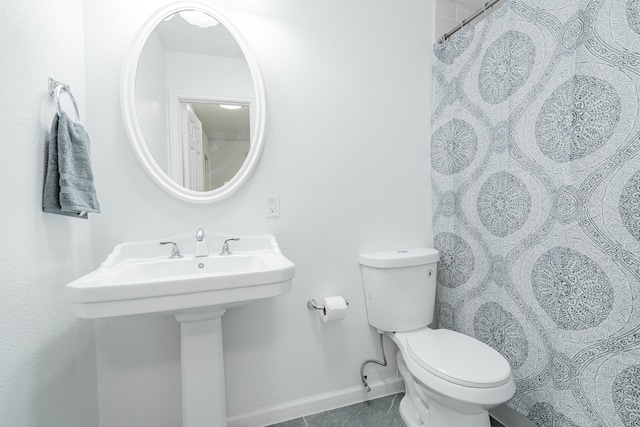 bathroom with sink, tile patterned flooring, toilet, and curtained shower