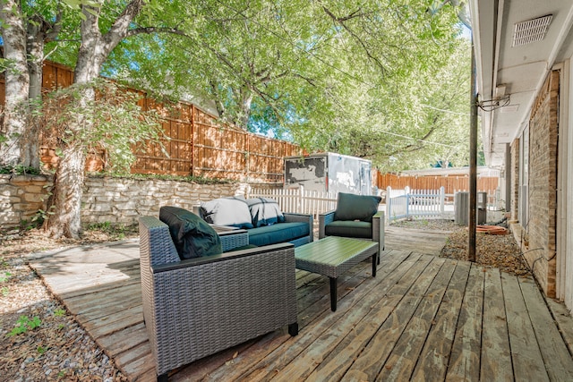 wooden deck with an outdoor living space and cooling unit