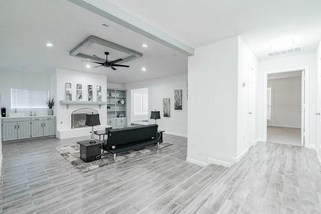 living room featuring ceiling fan and light hardwood / wood-style flooring