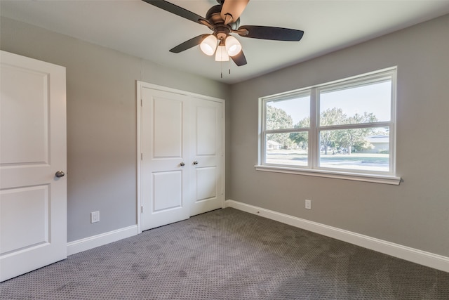 unfurnished bedroom featuring a closet, ceiling fan, and light colored carpet