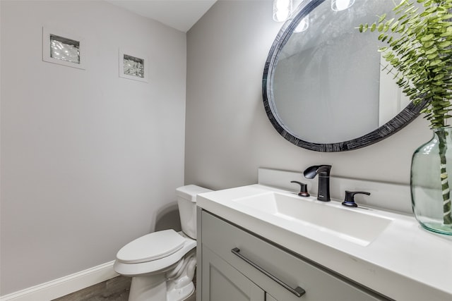 bathroom featuring hardwood / wood-style floors, vanity, and toilet