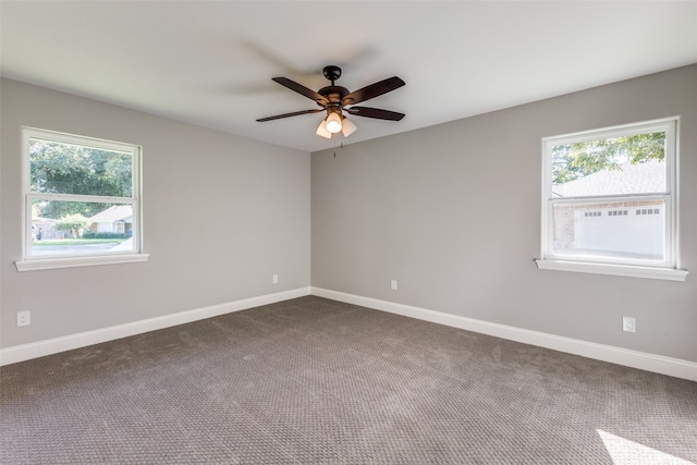 carpeted empty room featuring ceiling fan and a wealth of natural light