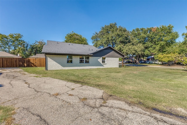 rear view of property with a yard