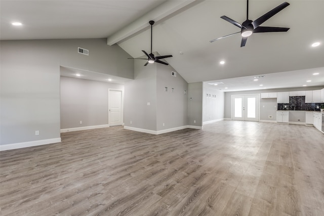 unfurnished living room featuring high vaulted ceiling, light wood-type flooring, beam ceiling, and ceiling fan