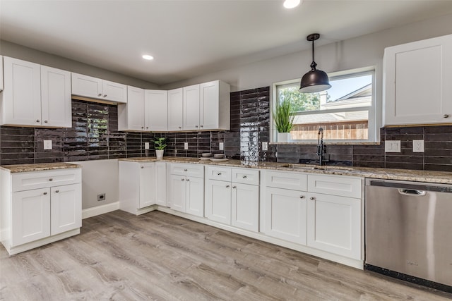 kitchen with white cabinets, light wood-type flooring, sink, and stainless steel dishwasher