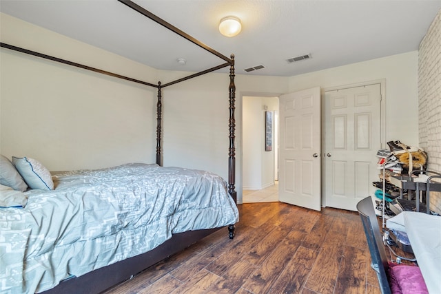 bedroom with dark hardwood / wood-style floors