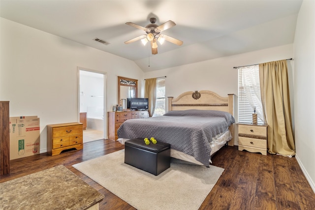 bedroom with ceiling fan, lofted ceiling, connected bathroom, and dark hardwood / wood-style flooring