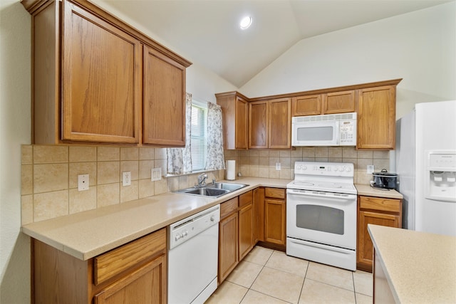 kitchen featuring lofted ceiling, light tile patterned floors, sink, white appliances, and backsplash