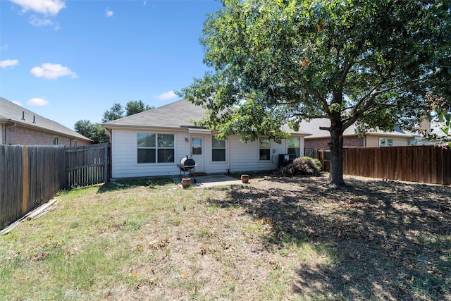 rear view of house featuring a patio and a yard