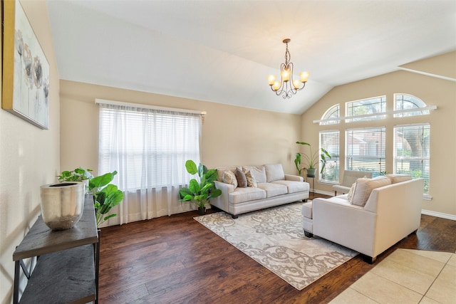 living room with a notable chandelier, wood-type flooring, and lofted ceiling