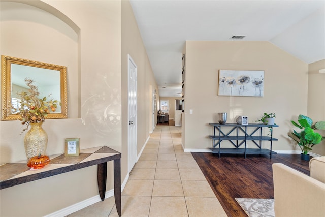 interior space with light hardwood / wood-style flooring and vaulted ceiling