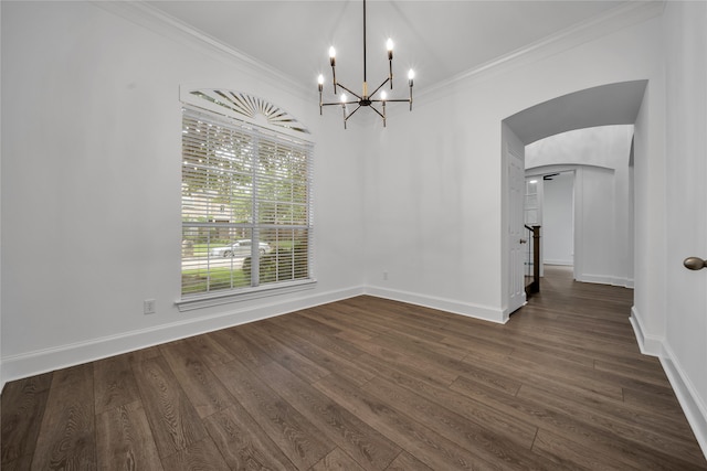 unfurnished dining area featuring dark wood-type flooring, ornamental molding, and a chandelier