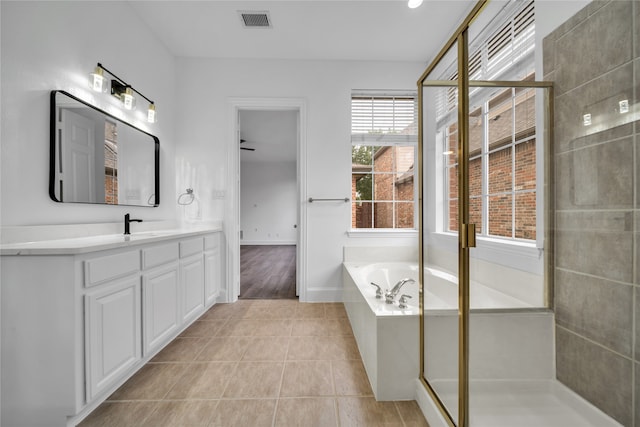 bathroom featuring vanity, shower with separate bathtub, and tile patterned flooring