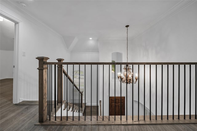 interior space featuring ornamental molding, hardwood / wood-style floors, and a notable chandelier