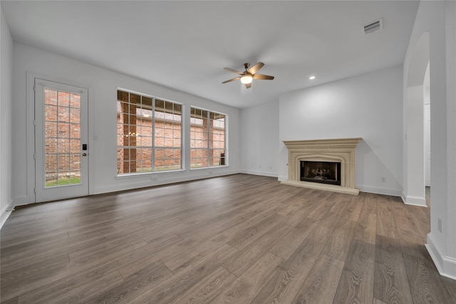 unfurnished living room featuring hardwood / wood-style flooring and ceiling fan