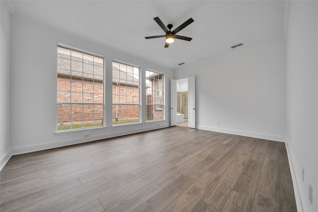 spare room featuring hardwood / wood-style floors and ceiling fan