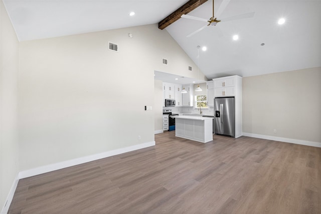 unfurnished living room featuring ceiling fan, beam ceiling, light hardwood / wood-style floors, and high vaulted ceiling