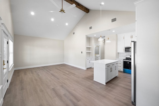 kitchen with ceiling fan, white cabinetry, pendant lighting, a kitchen island, and appliances with stainless steel finishes