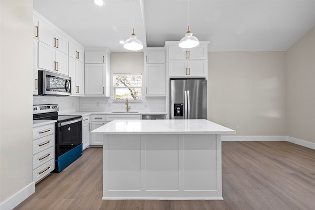 kitchen with white cabinets, a center island, and stainless steel appliances