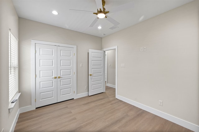 unfurnished bedroom featuring ceiling fan, a closet, and light hardwood / wood-style floors