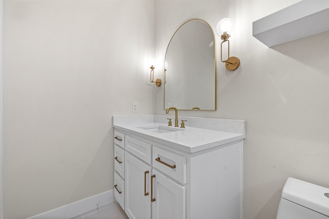 bathroom featuring tile patterned floors, vanity, and toilet