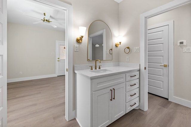 bathroom featuring ceiling fan, vanity, and hardwood / wood-style flooring