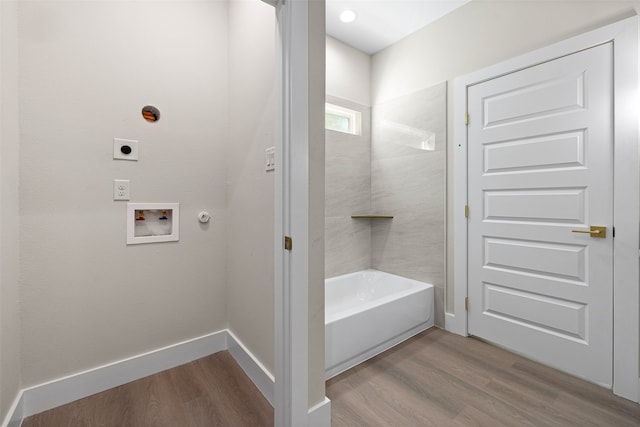 bathroom with a tub and hardwood / wood-style flooring