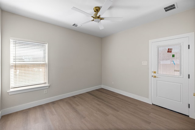 unfurnished room featuring ceiling fan, light hardwood / wood-style floors, and a wealth of natural light