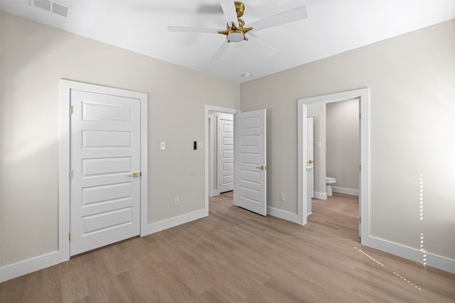 unfurnished bedroom featuring light hardwood / wood-style floors, ensuite bath, and ceiling fan