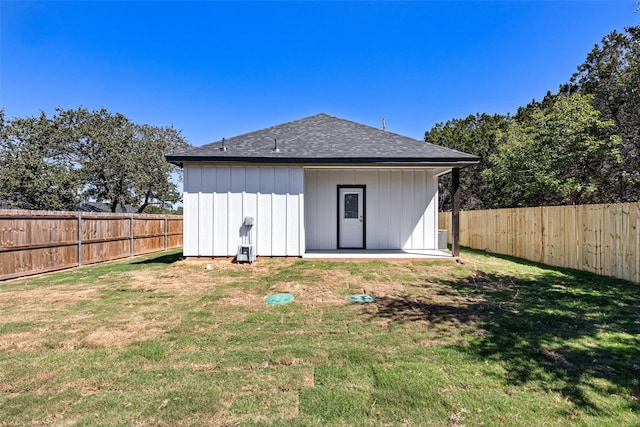 rear view of property featuring a lawn