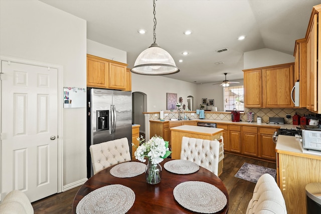 dining space with lofted ceiling, dark hardwood / wood-style floors, sink, and ceiling fan